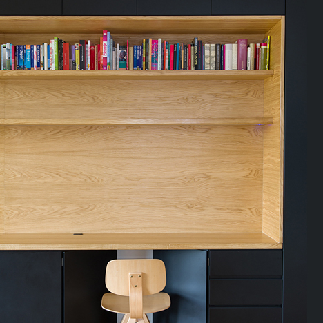 Wooden niches contain work surfaces and storage inside Black Line Apartment by Arhitektura d.o.o.