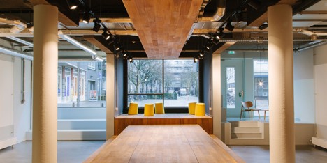 Wooden catwalk installed in conference room to encourage livelier presentations