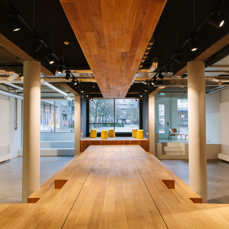 Wooden catwalk installed in conference room to encourage livelier presentations