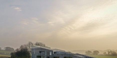 Flint House features rugged stone walls that gradate from smoky grey to chalky white