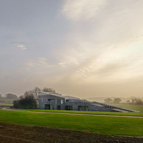 Flint House features rugged stone walls that gradate from smoky grey to chalky white