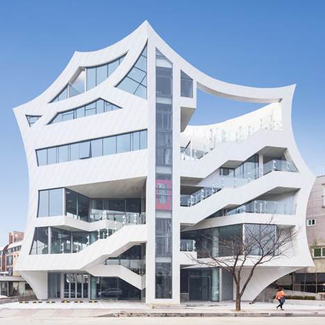 Concave walls give a scalloped outline to mixed-use block by Iroje KHM Architects