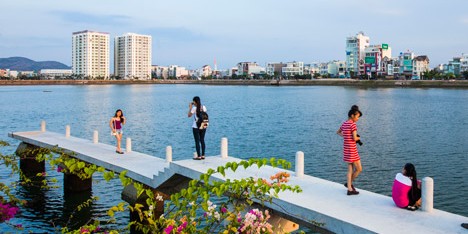 Waterside park by MIA Design Studio runs alongside a lake in Vietnam