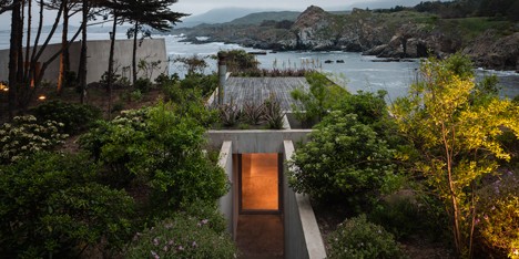 Concrete painter’s studio by Felipe Assadi nestles into a rocky hillside on the Chilean seafront