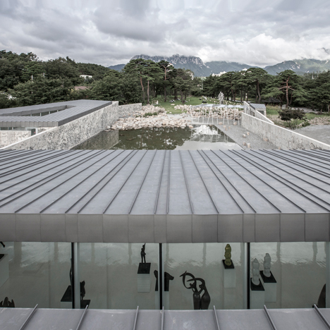 Craggy concrete walls surround South Korean sculpture park by Archium