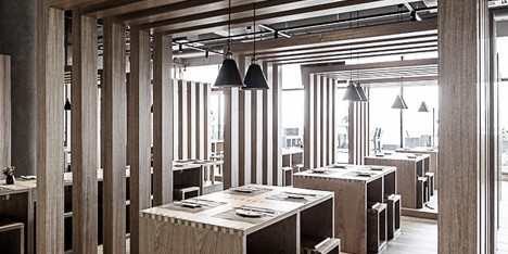 Slatted timber boxes contain dining areas inside Fanbo Zeng’s Fun noodle bar