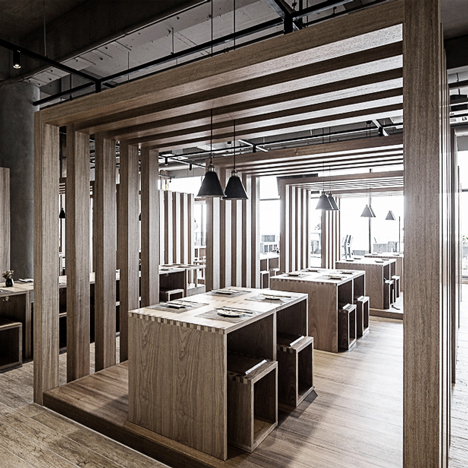 Slatted timber boxes contain dining areas inside Fanbo Zeng’s Fun noodle bar