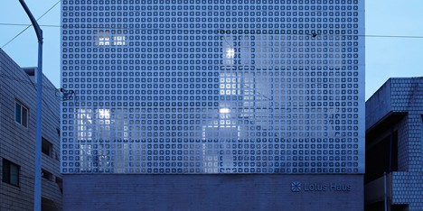 Perforated metal panels reveal a staircase in Smart Architecture’s Lotus Haus