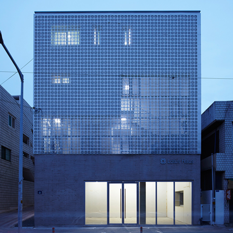 Perforated metal panels reveal a staircase in Smart Architecture’s Lotus Haus