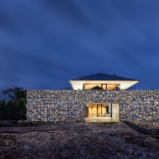 Observation House by I/O Architects features gabion walls and a grassy viewing deck