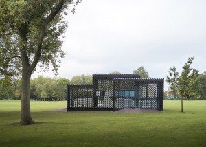 Photograph showing pavilion on grassy field with trees