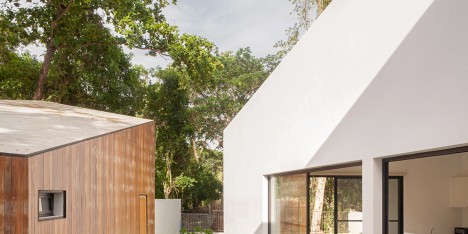 Ekar Architects completes canal-side house in Thailand with adjoining cafe and music room