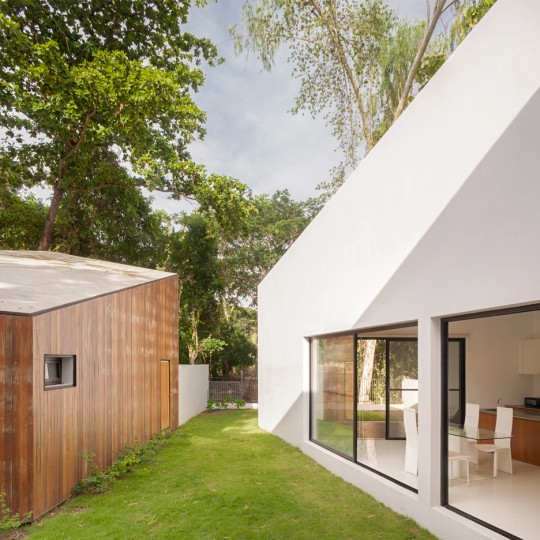 Ekar Architects completes canal-side house in Thailand with adjoining cafe and music room