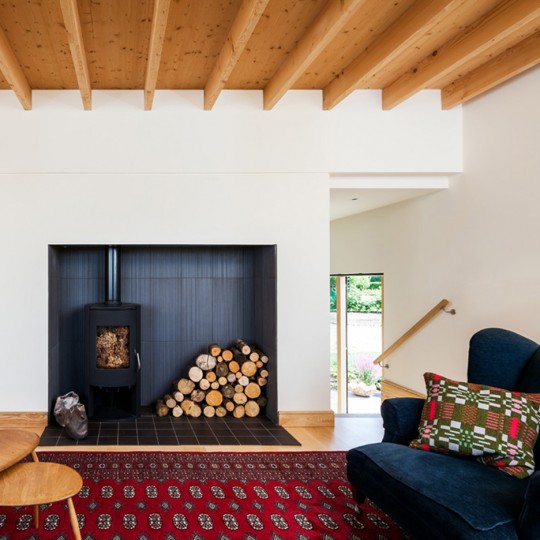 The living room is separate from the kitchen and dining spaces of Mole Architects' Stackyard