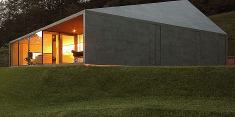 Faceted-home-in-the-Swiss-Alps-by-JM-Architecture-is-covered-in-dark-grey-tiles