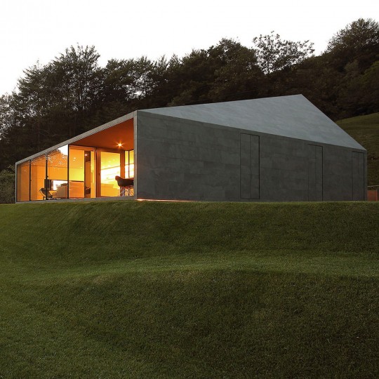 Faceted-home-in-the-Swiss-Alps-by-JM-Architecture-is-covered-in-dark-grey-tiles
