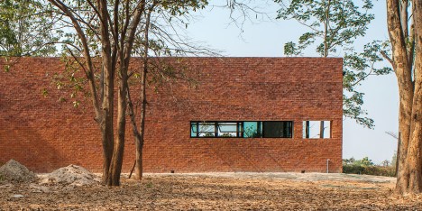 Layers of brick, concrete and glass define private spaces in a Thai home