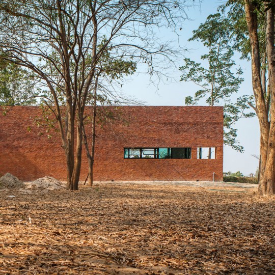 Layers of brick, concrete and glass define private spaces in a Thai home