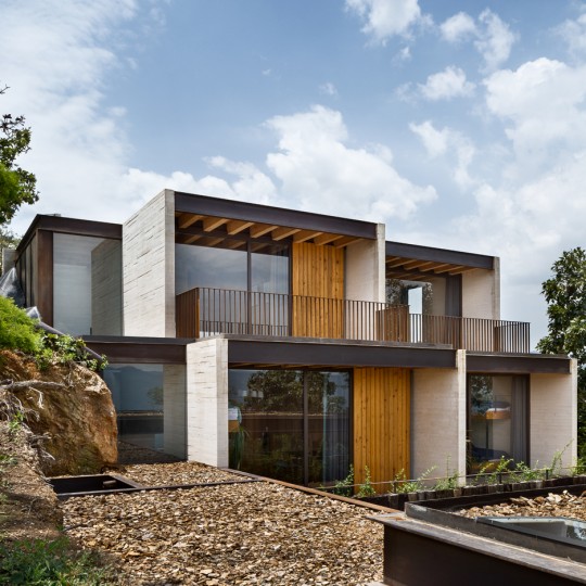 Concrete house in Mexico by Taller Hector Barroso cascades towards a lake