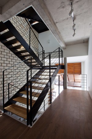 Townhouse with a folding-up shutter in Vietnam by MM++ Architects