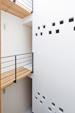 Townhouse with a folding-up shutter in Vietnam by MM++ Architects