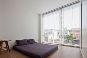 Townhouse with a folding-up shutter in Vietnam by MM++ Architects