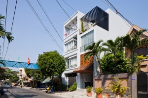 Townhouse with a folding-up shutter in Vietnam by MM++ Architects
