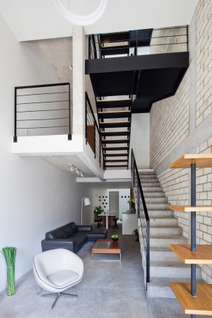 Townhouse with a folding-up shutter in Vietnam by MM++ Architects