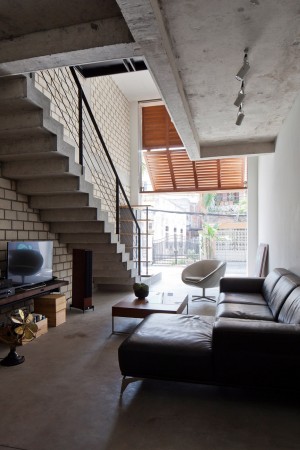 Townhouse with a folding-up shutter in Vietnam by MM++ Architects