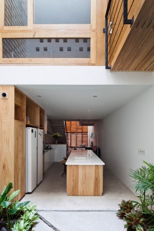 Townhouse with a folding-up shutter in Vietnam by MM++ Architects
