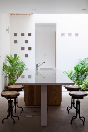 Townhouse with a folding-up shutter in Vietnam by MM++ Architects