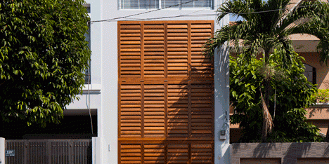 Townhouse with a folding-up shutter in Vietnam by MM++ Architects