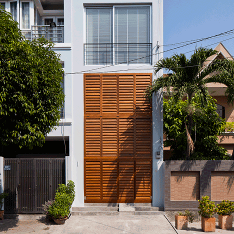 Townhouse with a folding-up shutter in Vietnam by MM++ Architects
