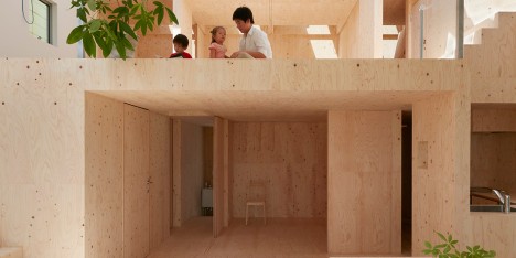 Wide sloping roof shelters plywood-filled house in Kobe by Tomohiro Hata