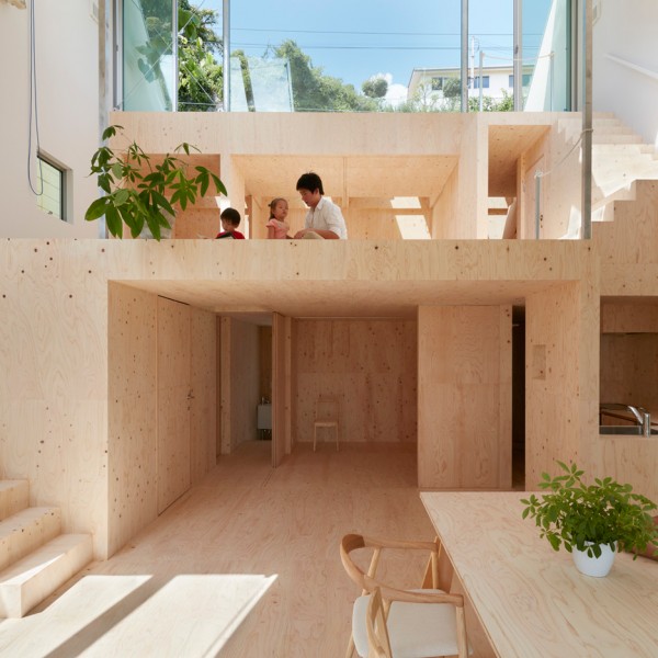 Wide sloping roof shelters plywood-filled house in Kobe by Tomohiro Hata