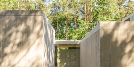 Sculp IT organises concrete boxes around glass corridor to create Belgian woodland home