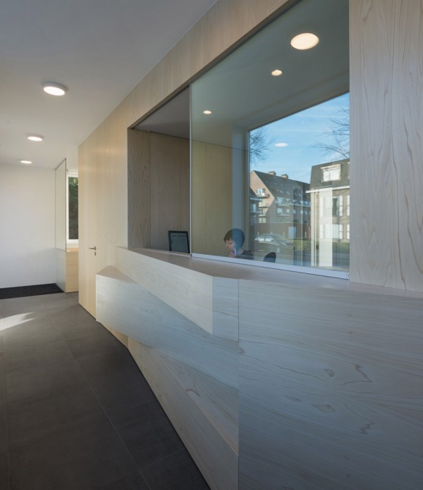Joshua Florquin uses angular joinery to create bespoke furnishings for doctor's surgery in Maldegem, Belgium