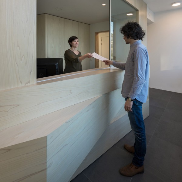 Joshua Florquin uses angular joinery to create bespoke furnishings for doctor's surgery in Maldegem, Belgium