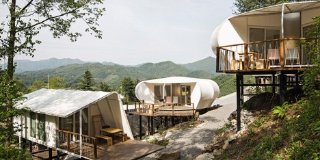 Wooden cabins and tents on stilts provide accommodation at South Korean glamping site