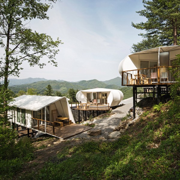 Wooden cabins and tents on stilts provide accommodation at South Korean glamping site