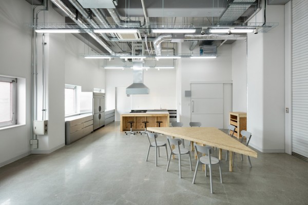 Hue Plus kitchen studio and library housed in a renovated warehouse building in Tokyo, Japan by Schemata Architects