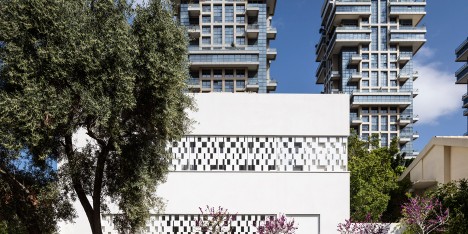 Perforated shutters create geometric facade for Pitsou Kedem’s house in Tel Aviv