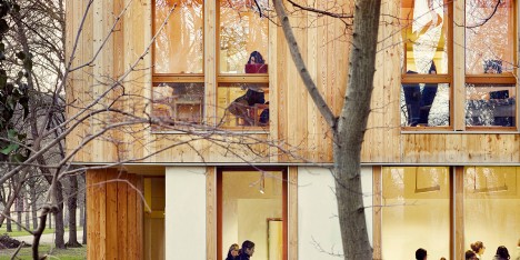 Timber and glass dormitory building nestles among trees in a Paris park