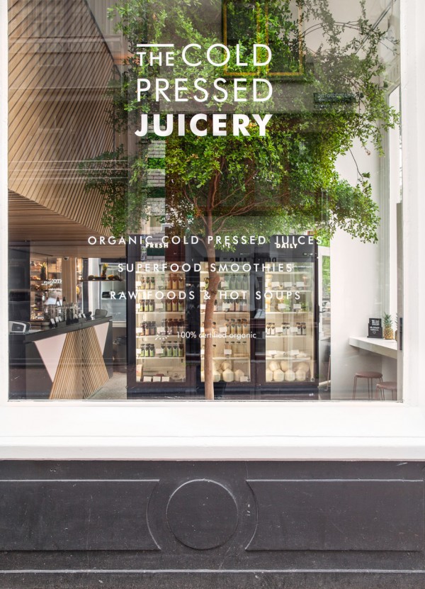 The Cold Pressed Juicery in Amsterdam designed by Standard Studio houses a living tree