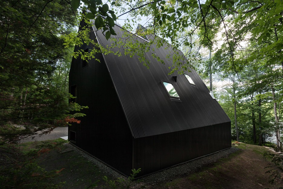 Jean Verville creates black fairytale-like cottage in a Quebec forest