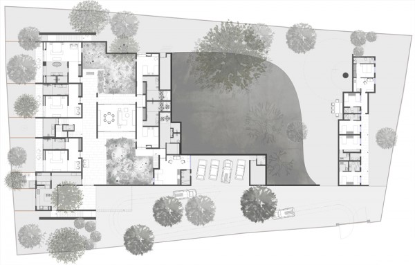 Spasm Architects clad Indian house in local stone and wrap it around a sunken courtyard.