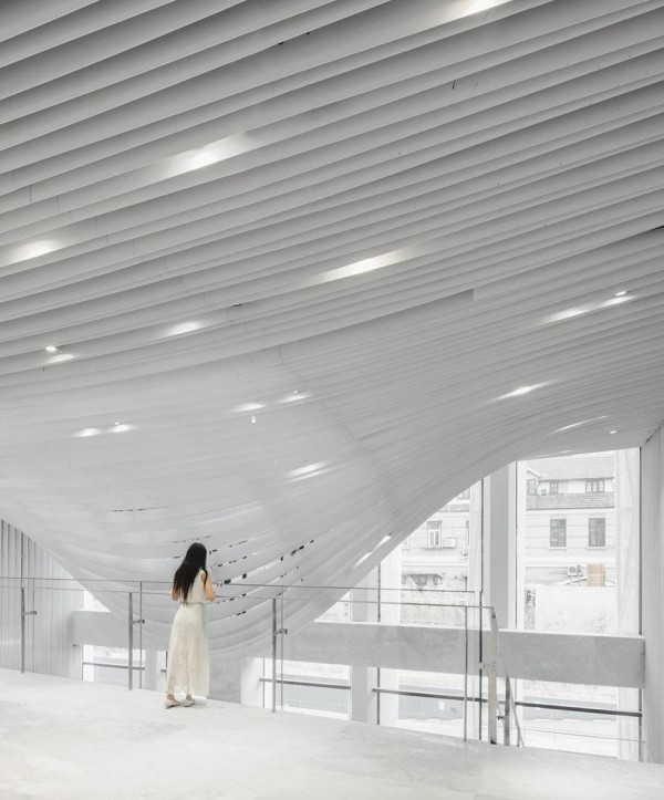 Strips of pleated aluminium are added to the facade of this Shanghai tower by Kengo Kuma