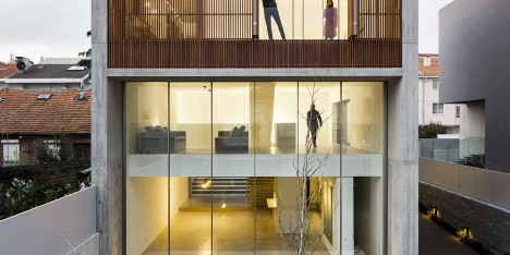 AZO Sequeira mask glazed walls with wooden screens in this house in Porto