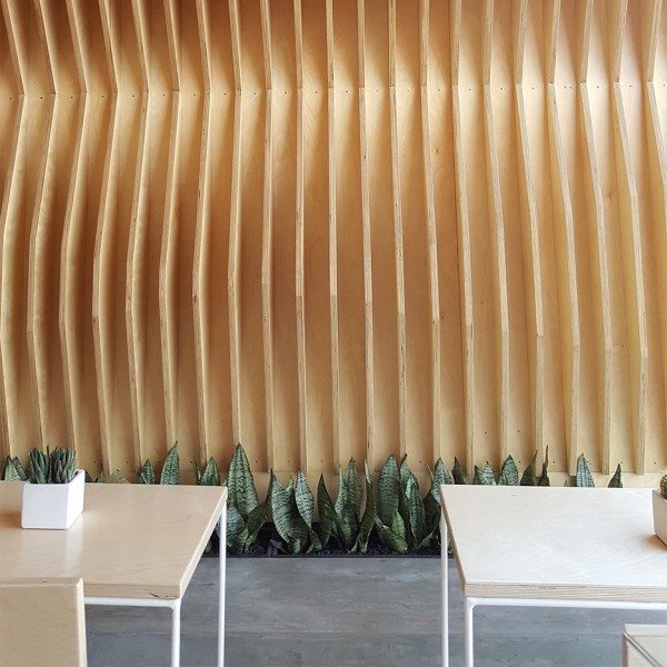 A-Industrial clads juice store interior with geometric plywood