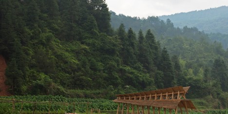 Huge timber steps form bridge built by students across a river in rural China